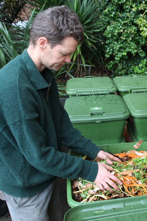 This is a photo of a person sifting through food scraps in a Hungry Bin.