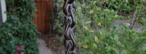 Bronze Droplet Rain Chain with water flowing down the chain