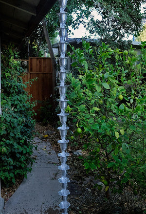 Aluminum Flower Cups Rain Chain hanging from homes gutter