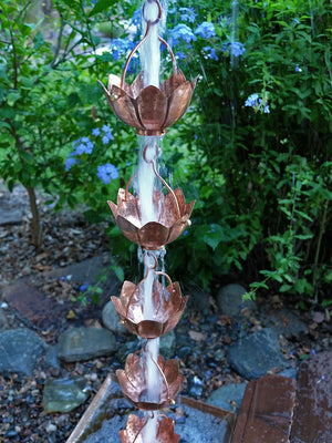 Buddha's Cup Copper Rain Chain on house with water flowing through multiple cups
