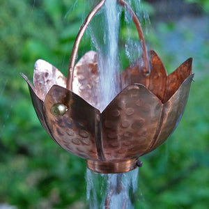 Buddha's Cup Copper Rain Chain with water flowing through cup