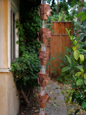 Copper Butterfly Rain Chain hanging from a home