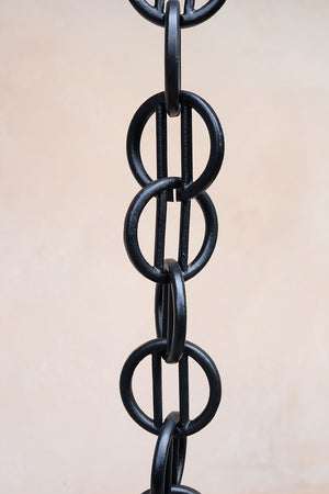 Close up of multiple black Cast Zen Loops Rain Chain links