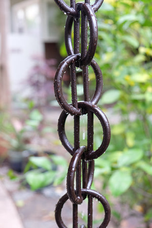 Close up of multiple bronze Cast Zen Loops Rain Chain links