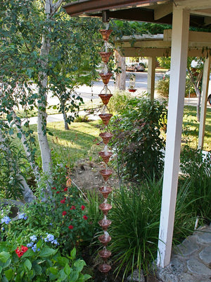 Copper Florence Cup Rain Chain on house with water flowing through multiple cups