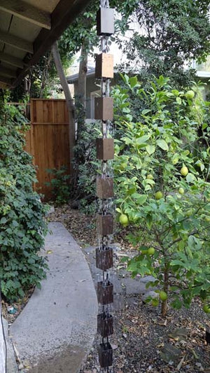 Square Kenchiku Aluminum Bronze Rain Chain on home with water running through multiple cups