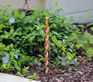 Copper rain chain anchor stake in flower bed