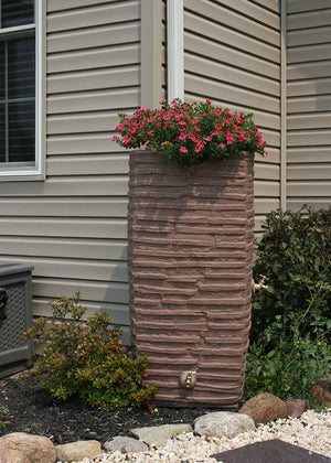 Impressions Riverwalk 50 Gallon Rain Saver in Red Brick next to a tan house
