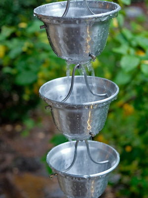 Aluminum Bell Cups Rain Chain with water flowing through multiple cups