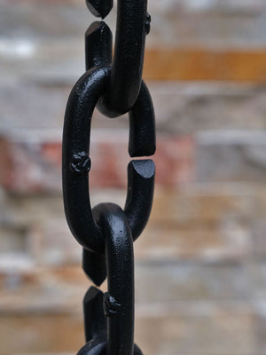 very closeup view of Cast Oval Links Rain Chain in black