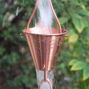 Copper colored Steel Cups Rain Chain with water running through cups