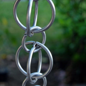 close up view of stainless steel double loops rain chain