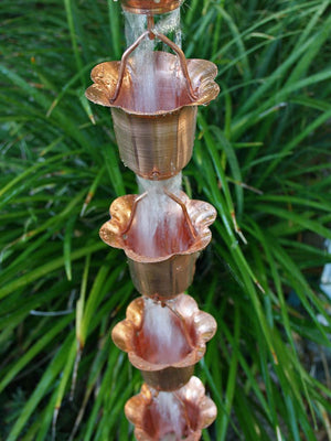 Copper Flower Cups Rain Chain with water flowing through multiple cups