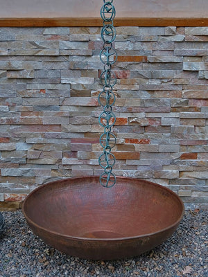 hand hammered copper basin under Rain Chain