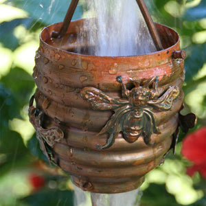 Honeybee & Hive Copper Rain Chain with water flowing through cup