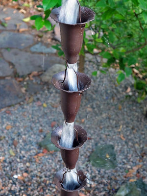 Bronze Honeysuckle Rain Chain with water running through multiple cups