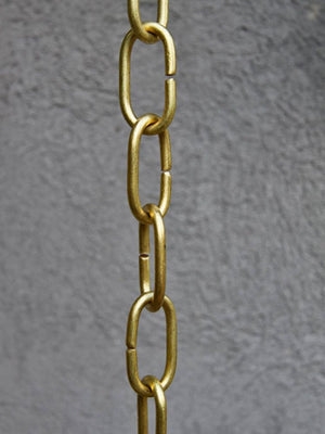 View showing Large Brass Link Rain Chain next to a stucco home