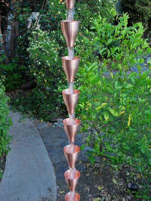 Copper Smooth Cups Rain Chain on house with water flowing through multiple cups