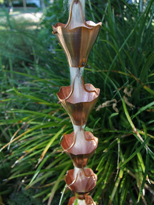 Star Flower Cups Rain Chain in platted copper with water flowing through multiple cups