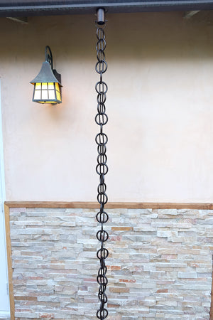 Bronze Cast Zen Loops Rain Chain on home