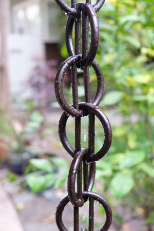 Bronze Cast Zen Loops Rain Chain in rain storm