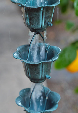 Flower Cups Rain Chain in Patina with water flowing through cups