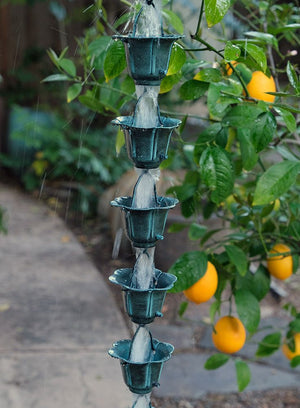 Flower Cups Rain Chain in Patina during a rainstorm