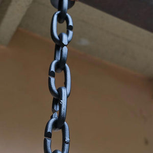 Cast Oval Links Rain Chain in Black on gutter