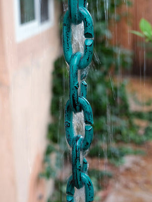 Cast Oval Links Rain Chain in Patina finish with water running down the chain