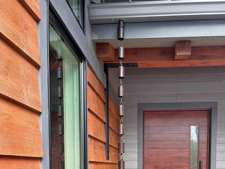 Bronze Kenchiku Rain Chain installed on a beautiful modern home