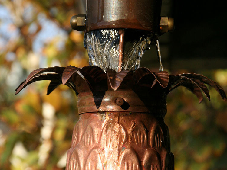 Pineapple Cups Rain Chain that has started to patina