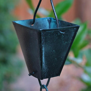 This is a close up photo of our Tapered Square Cups Rain Chain with a Patina Finish. One of our popular cup style rain chains. Click the image to shop all of our cup style rain chains.