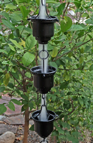 Black Naoki Cups Rain Chain with water flowing through multiple cups