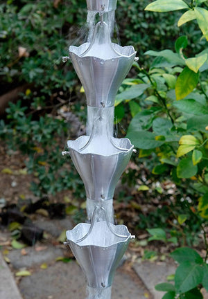 Star Flower Cups Rain Chain in aluminum with water flowing through multiple cups