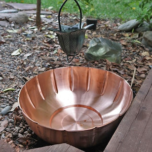 Scallop copper dish basin at base of rain chain