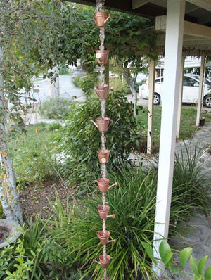 Watering Can copper Cups Rain Chain with water flowing through watering can shaped cups on house