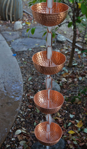rainwater running through a longer length of Singing Bowls™ Copper Rain Chain