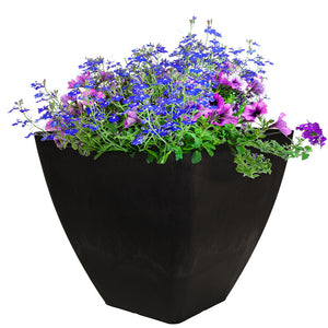 Close up photo of 12 inch square garden planter in graphite color with flowers