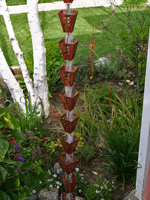 Arts & Crafts Copper Square Cups Rain Chain in garden with water flowing through multiple cups