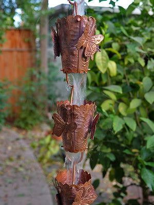 Butterfly Theme Copper Rain Chain with water flowing through multiple cups