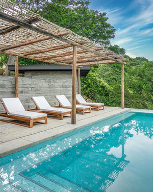 Casares Teak Chaise Lounge Chair by tropical pool 