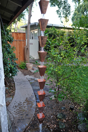 Full length image of Large Tapered Cup style rain chain in Copper with water running through cups