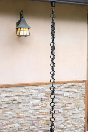 Cast Zen Loops Rain Chain full length image next to home