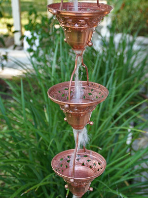 Copper Florence Cup Rain Chain with water flowing through multiple cups