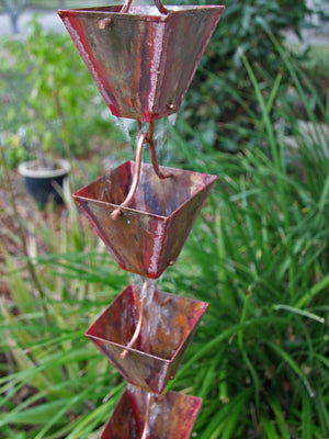 Medium Square Cups Aged Copper Rain Chain showing four cups with water flowing down