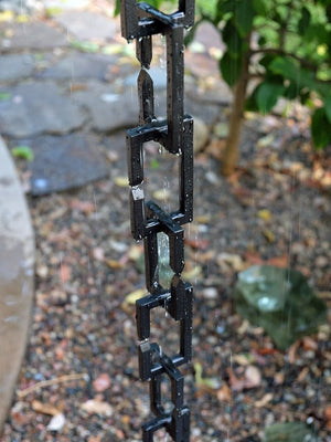 Black Rectangle Links Rain Chain with flowing rain water in garden