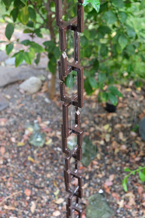 Rectangle Links Rain Chain with flowing rain water in garden