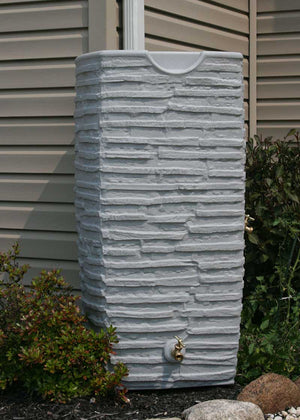 Impressions Riverwalk 50 Gallon Rain Saver in Light Granite next to a tan house