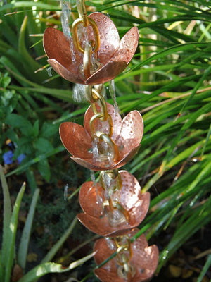 Tara Flower Copper Cup Style Rain Chain with water flowing through multiple cups
