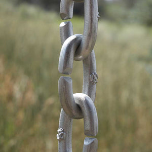 Close up of XL Cast Oval Links Rain Chain in clear powder-coated aluminum